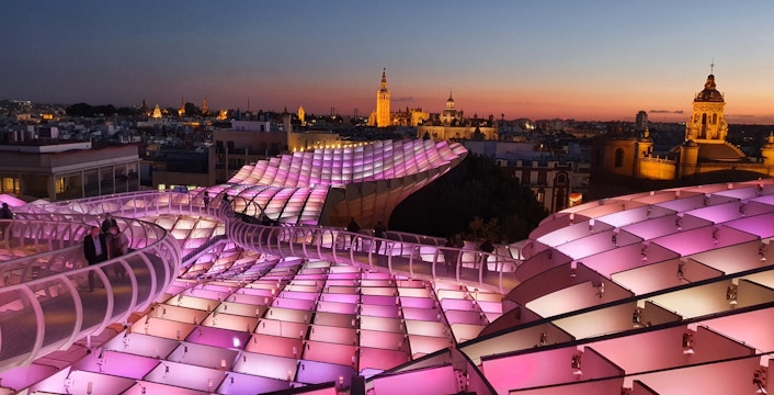 Visitors walking on illuminated Setas de Sevilla at night, Seville, Spain.
