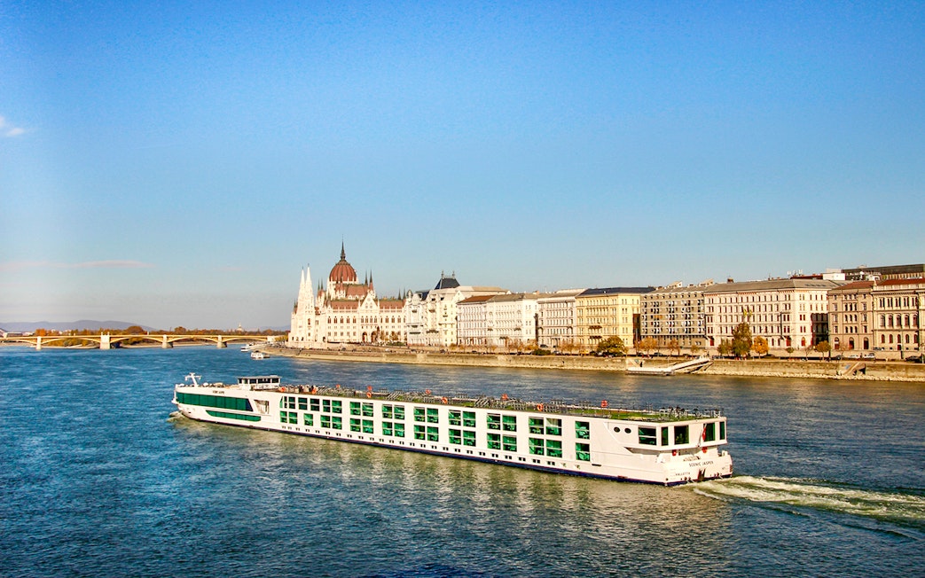Cruise ship on the Danube River with Budapest Parliament in the background.