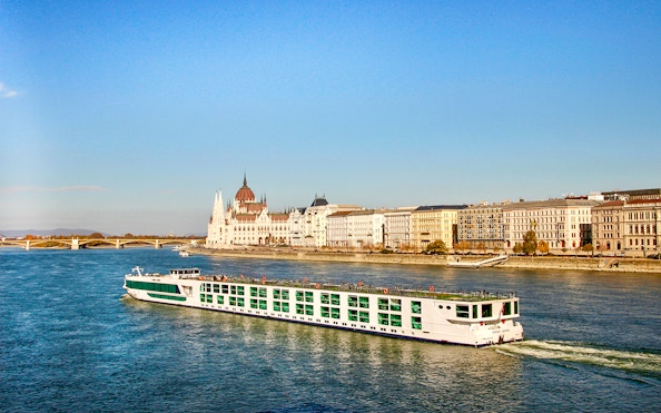 Cruise ship on the Danube River with Budapest Parliament in the background.