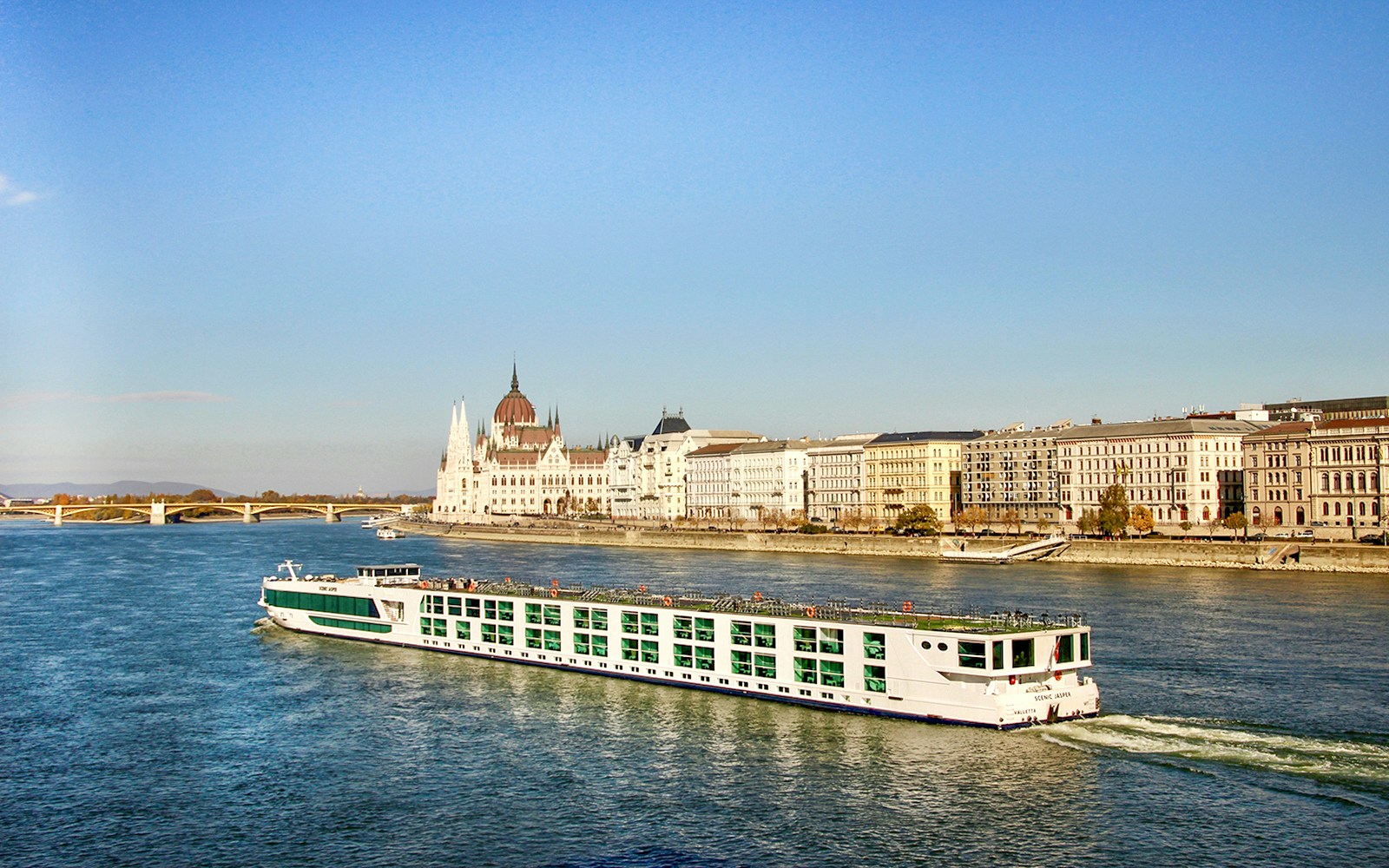 Cruise ship on the Danube River with Budapest Parliament in the background.