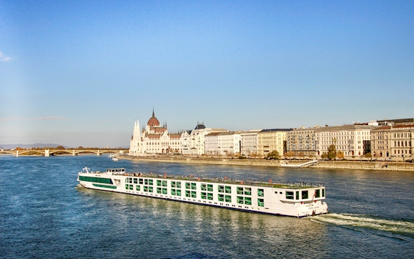 Cruise ship on the Danube River with Budapest Parliament in the background.