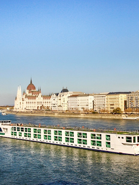 Cruise ship on the Danube River with Budapest Parliament in the background.