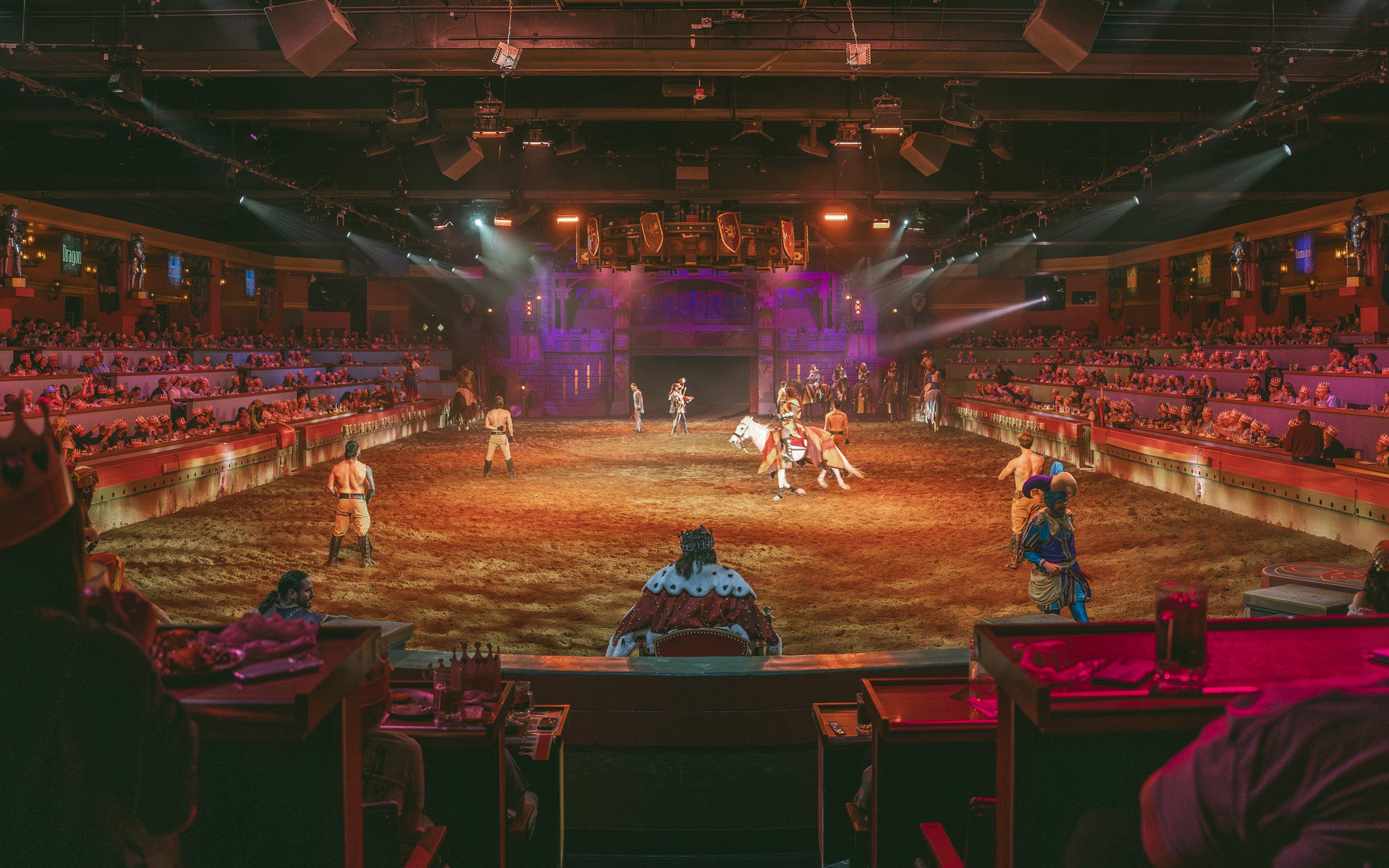 Medieval knights performing at Tournament of Kings show in Las Vegas arena.