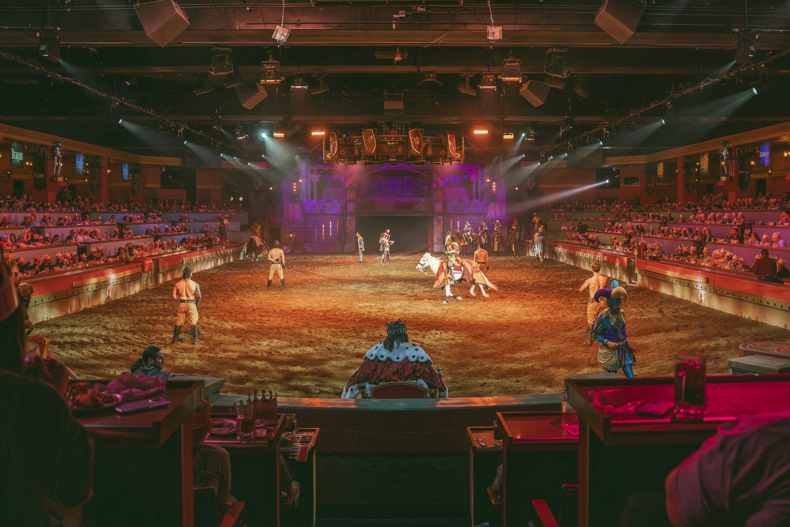 Medieval knights performing at Tournament of Kings show in Las Vegas arena.