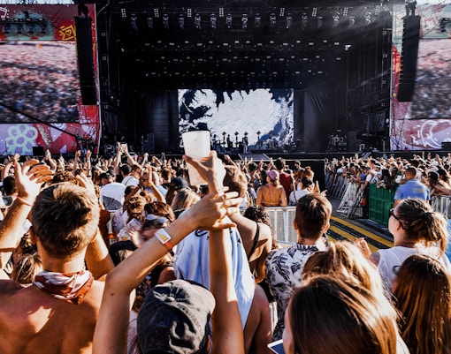 Vienna music festival attendees enjoying a live orchestral performance in an open-air venue.