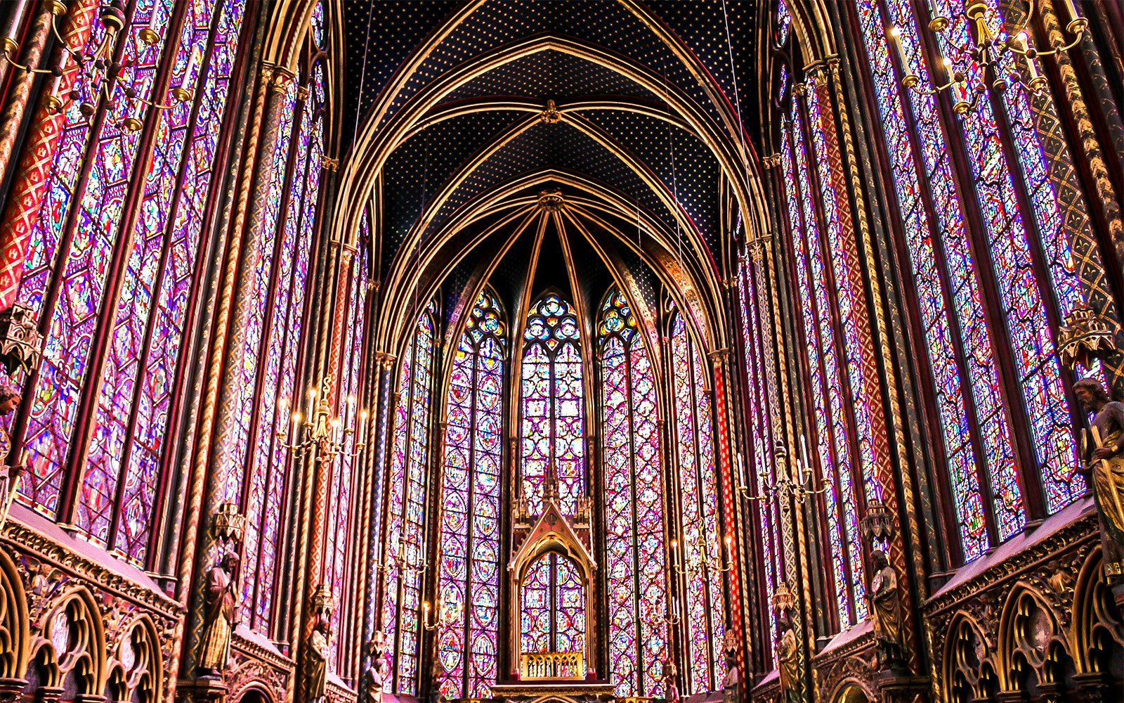 Sainte Chapelle's intricate stained glass windows in Paris, showcasing vibrant colors and Gothic architecture.