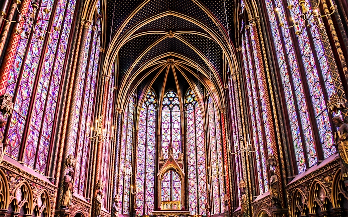 Sainte Chapelle's intricate stained glass windows in Paris, showcasing vibrant colors and Gothic architecture.