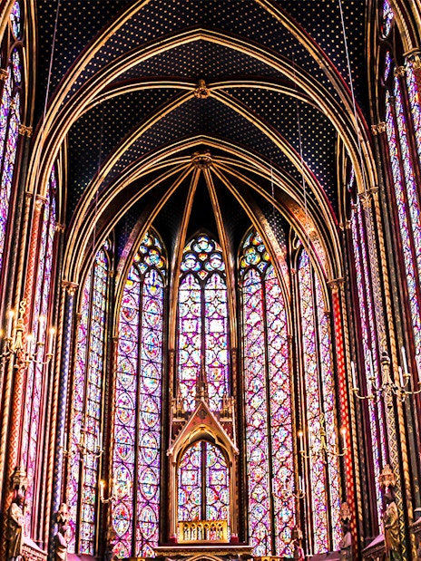 Sainte Chapelle's intricate stained glass windows in Paris, showcasing vibrant colors and Gothic architecture.