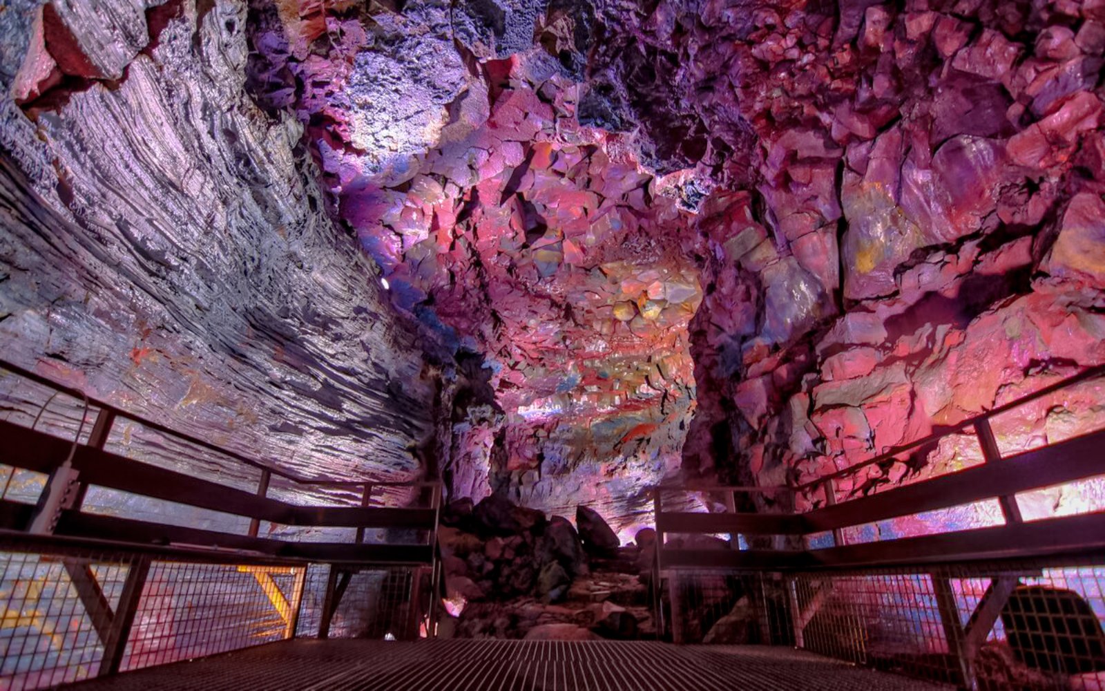 Inside view of Raufarhólshellir Lava Tunnel with colorful rock formations.