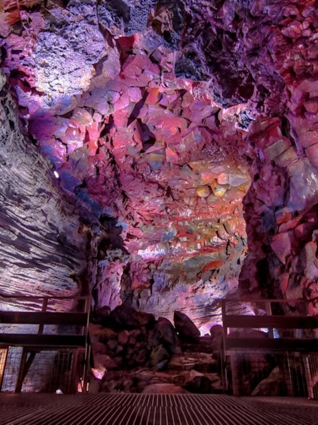 Inside view of Raufarhólshellir Lava Tunnel with colorful rock formations.