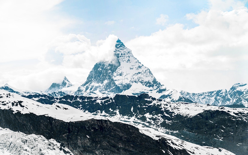 Matterhorn peak view from cable car, snow-covered Alps, Switzerland.
