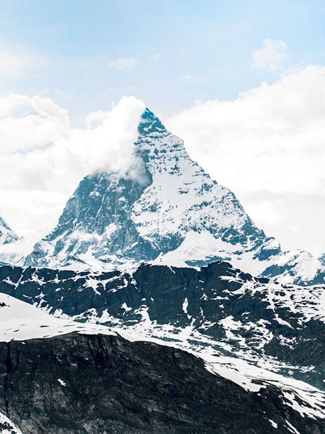 Matterhorn peak view from cable car, snow-covered Alps, Switzerland.