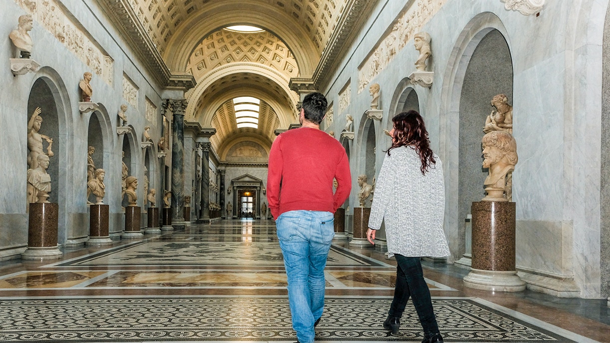 Tour group walking through Braccio Nuovo, Vatican Museums, Rome.