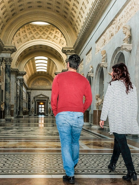 Tour group walking through Braccio Nuovo, Vatican Museums, Rome.