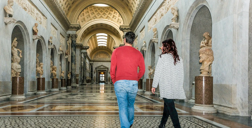 Tour group walking through Braccio Nuovo, Vatican Museums, Rome.