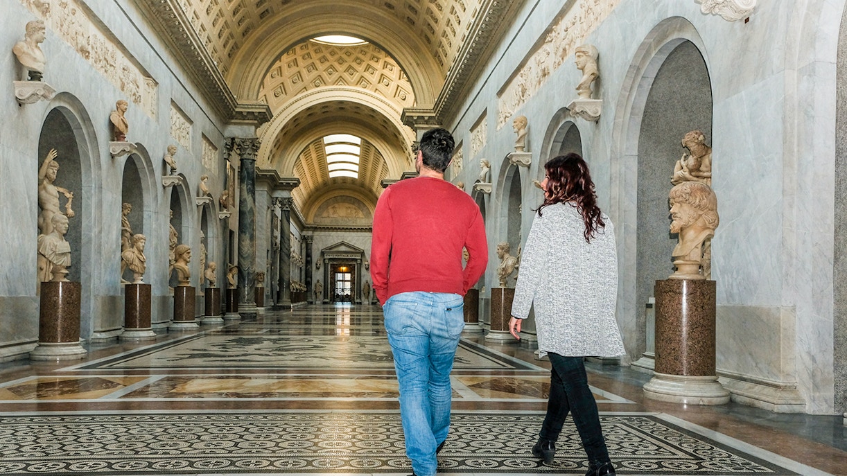 Tour group walking through Braccio Nuovo, Vatican Museums, Rome.
