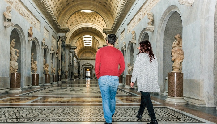Guided tour group in Braccio Nuovo, Vatican Museums, Rome, Italy, early morning exploration.