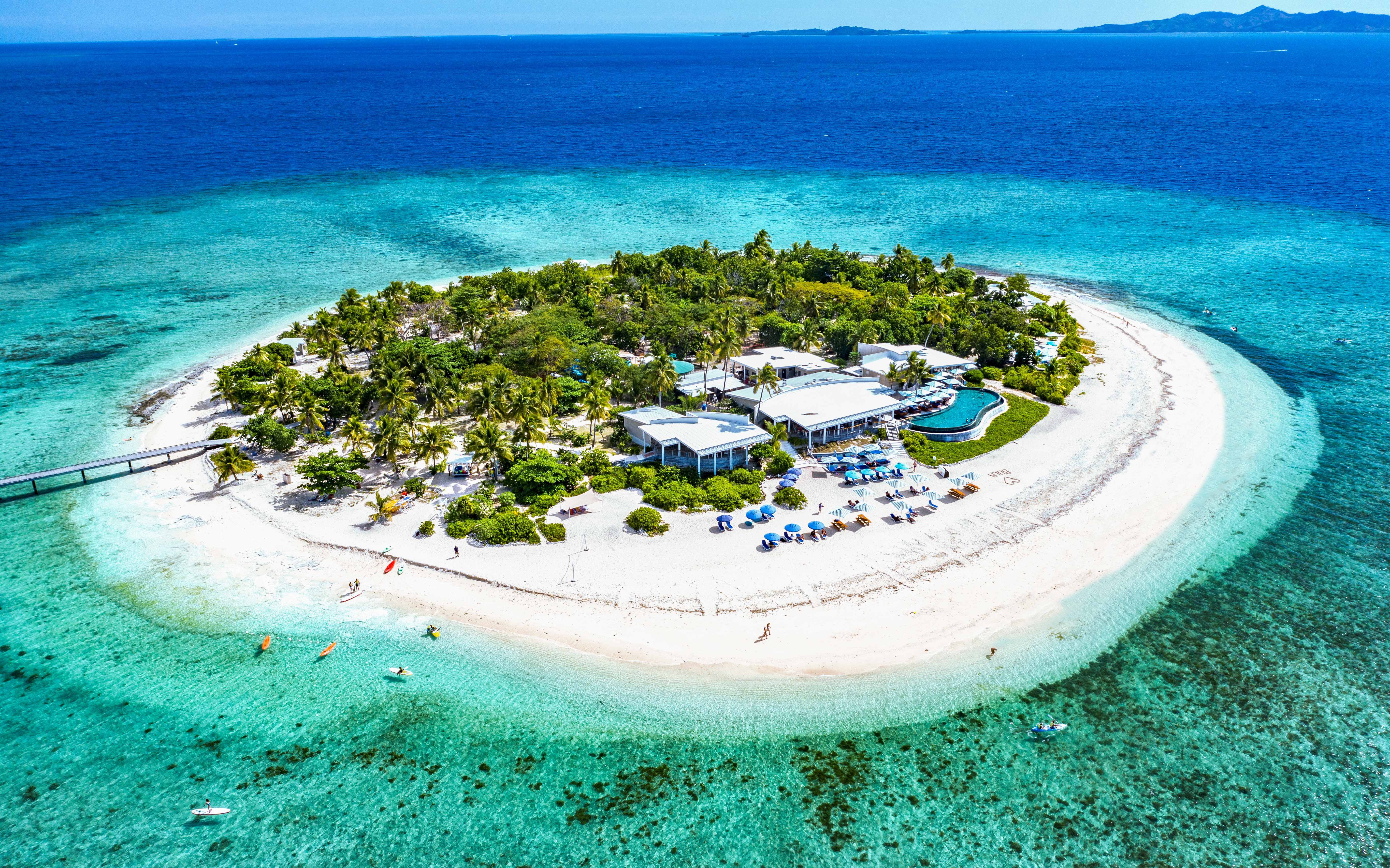 Aerial view of Malamala Beach Club, Fiji, featuring white sandy beach and turquoise waters.