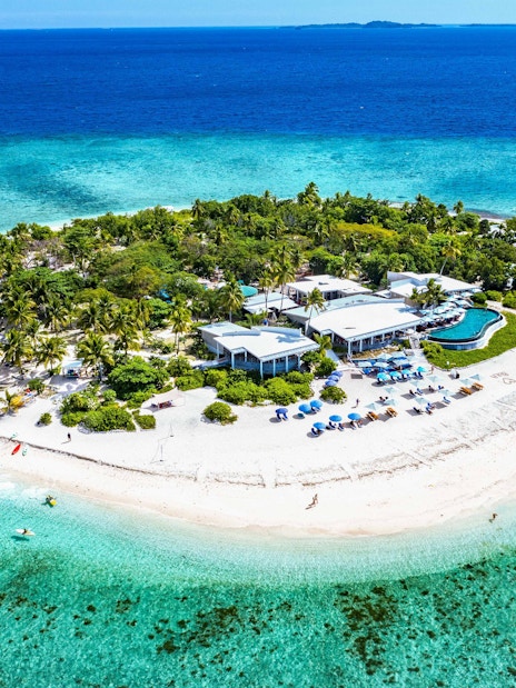 Aerial view of Malamala Beach Club, Fiji, featuring white sandy beach and turquoise waters.
