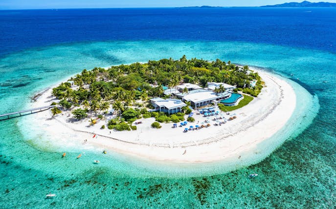 Aerial view of Malamala Beach Club, Fiji, featuring white sandy beach and turquoise waters.