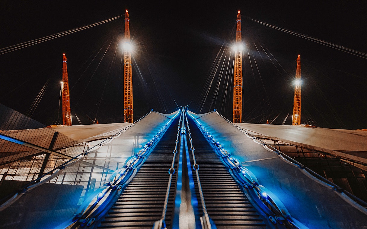 Climbing path illuminated at night on the O2 Arena roof in London.