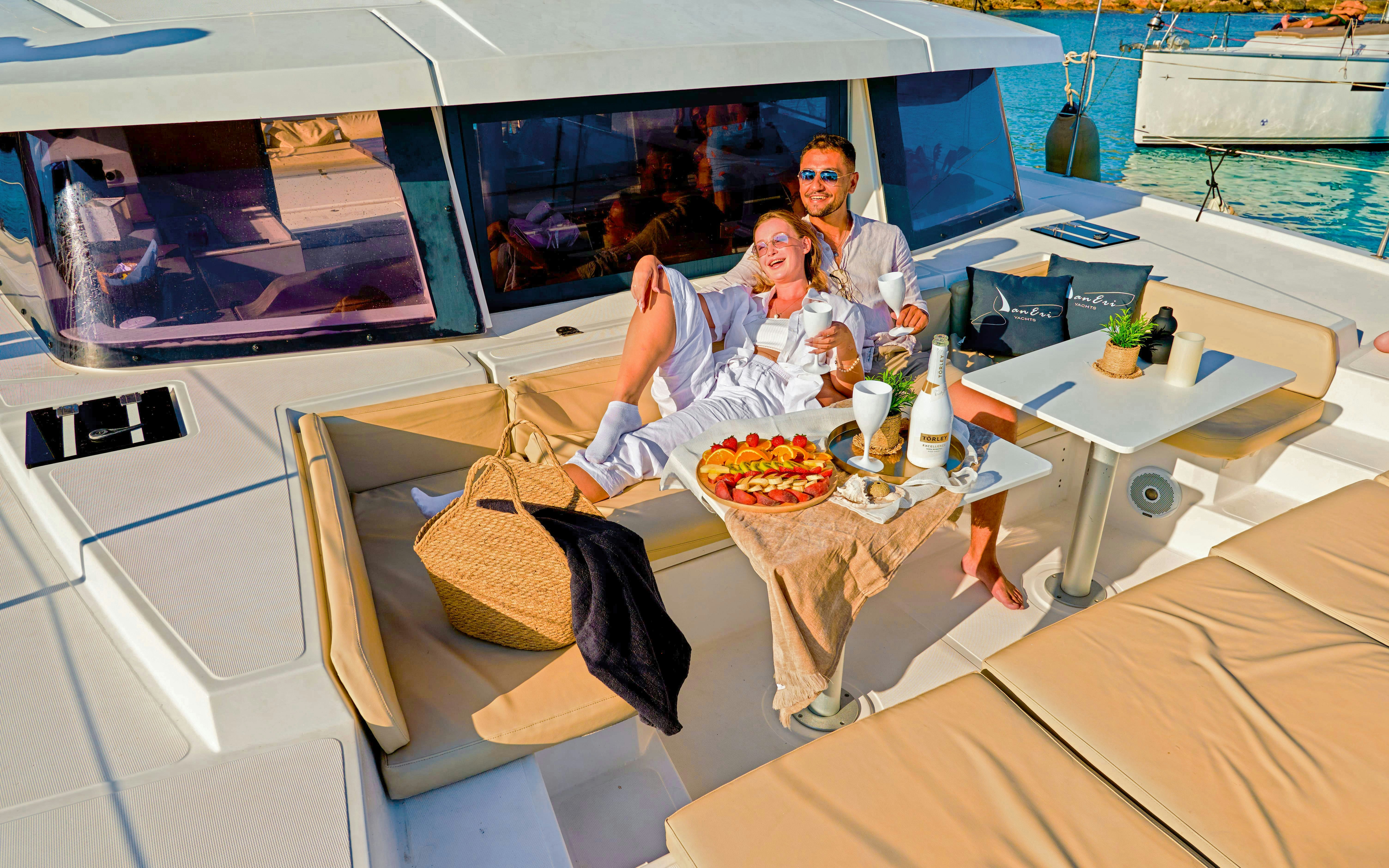 Lunch on a luxury catamaran cruise to Chrissi Island with a couple enjoying drinks and snacks.