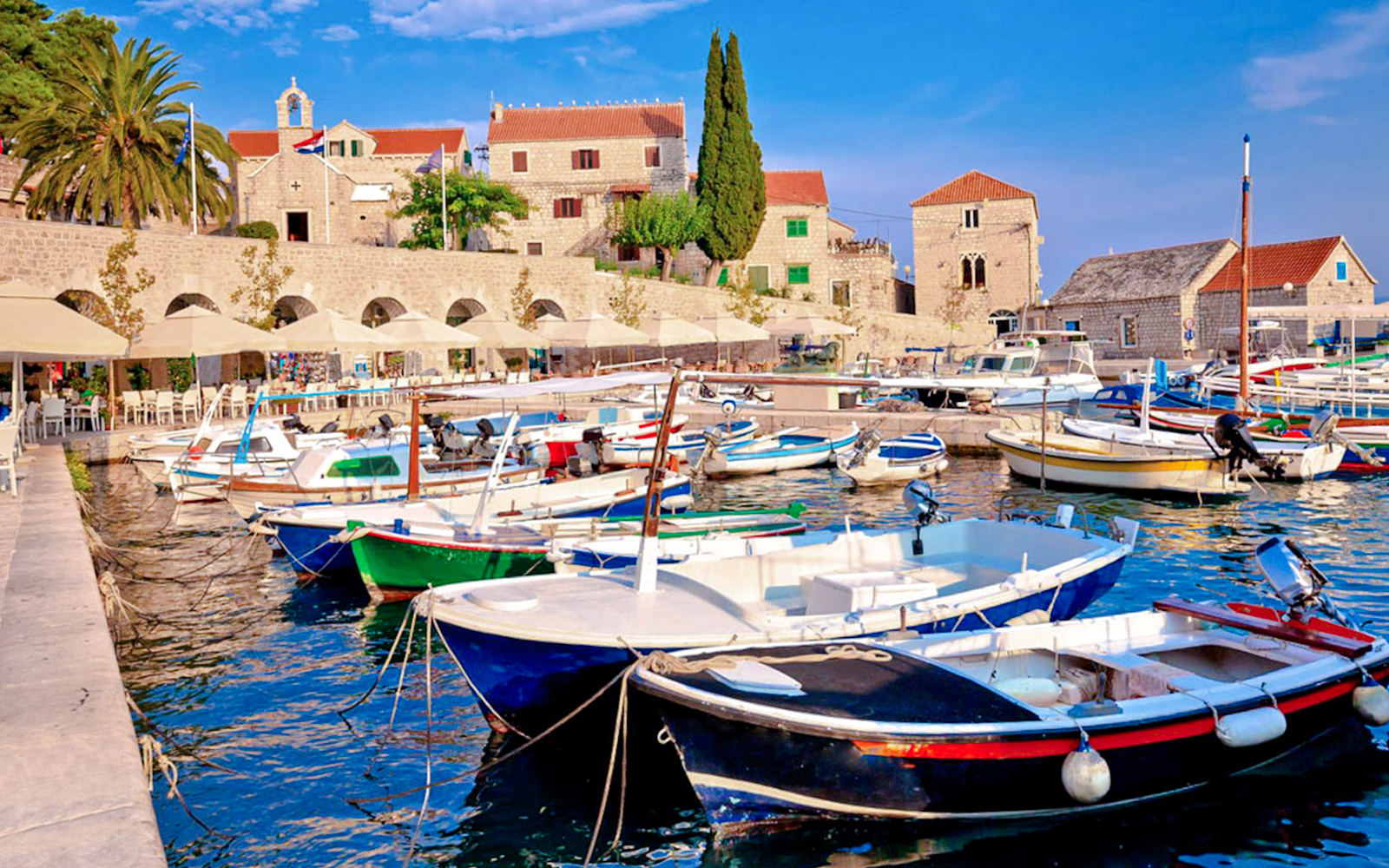 Boats docked at Bol Island harbor during Blue Lagoon, Golden Horn & Hvar Speedboat Tour.