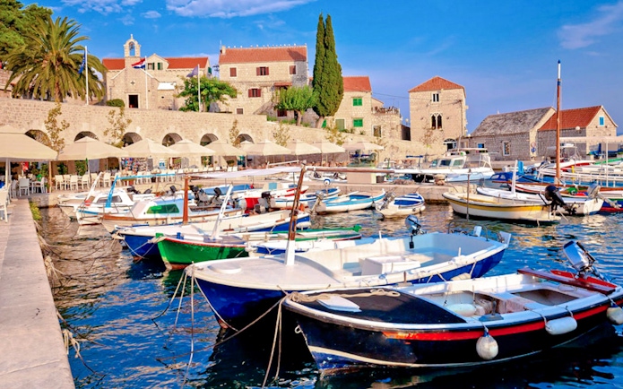 Boats docked at Bol Island harbor during Blue Lagoon, Golden Horn & Hvar Speedboat Tour.