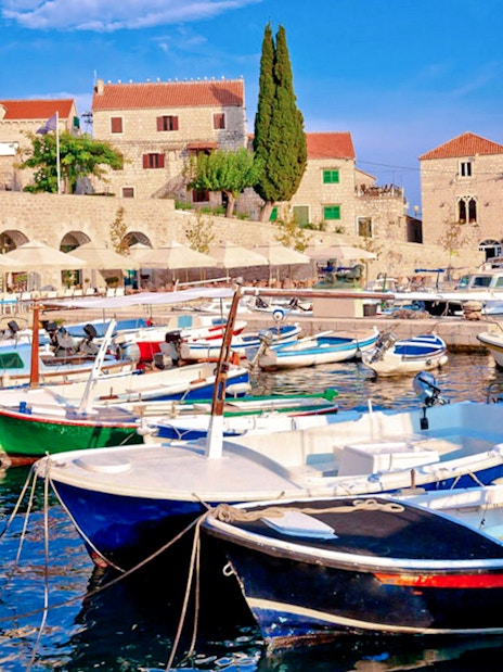 Boats docked at Bol Island harbor during Blue Lagoon, Golden Horn & Hvar Speedboat Tour.