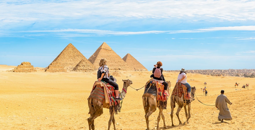 Giza Pyramids and Sphinx with tourists on a half-day guided tour in Cairo, Egypt.