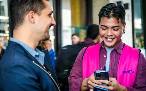 Terravision staff assisting a traveler with mobile booking
