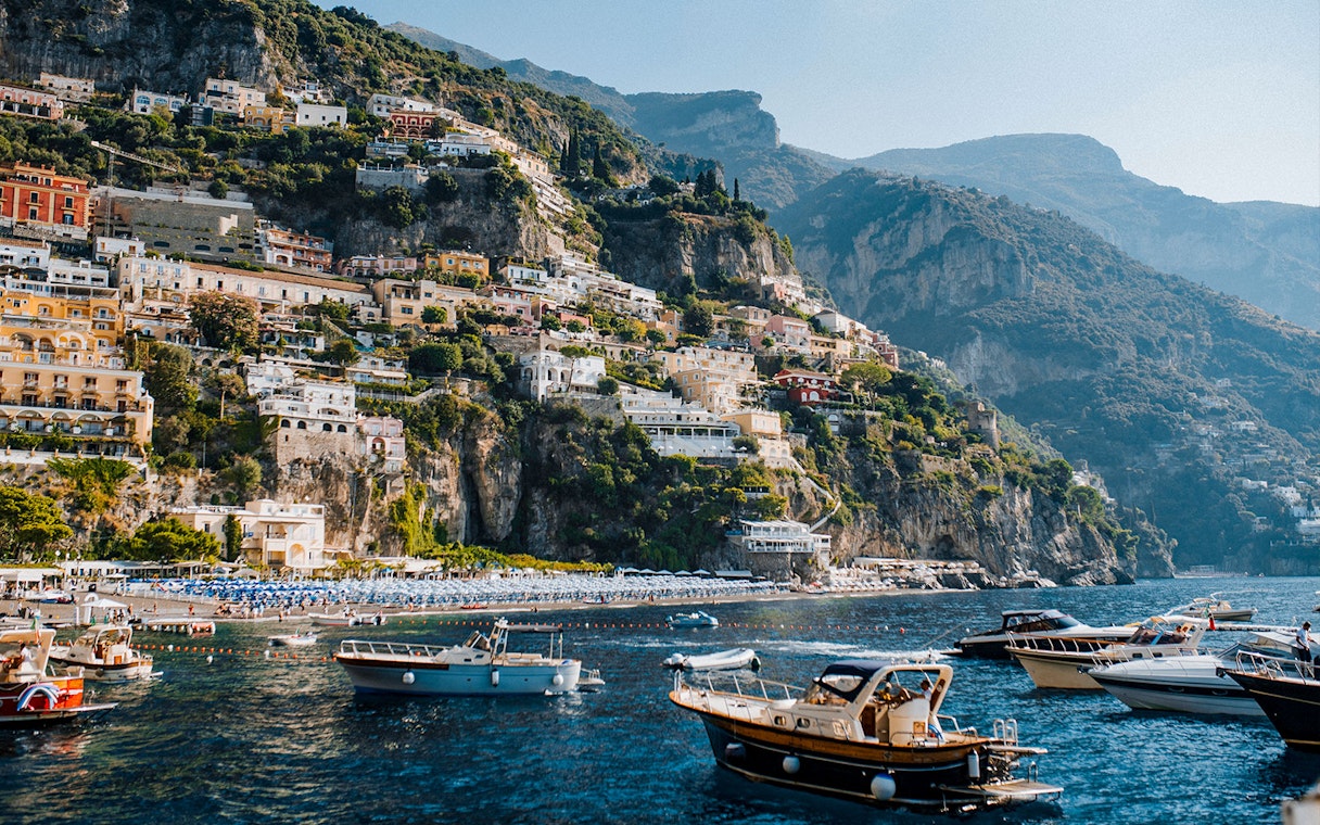 Positano's colorful cliffside buildings and boats on the Amalfi Coast.