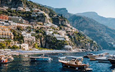 Positano's colorful cliffside buildings and boats on the Amalfi Coast.