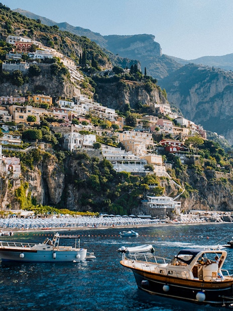 Positano's colorful cliffside buildings and boats on the Amalfi Coast.
