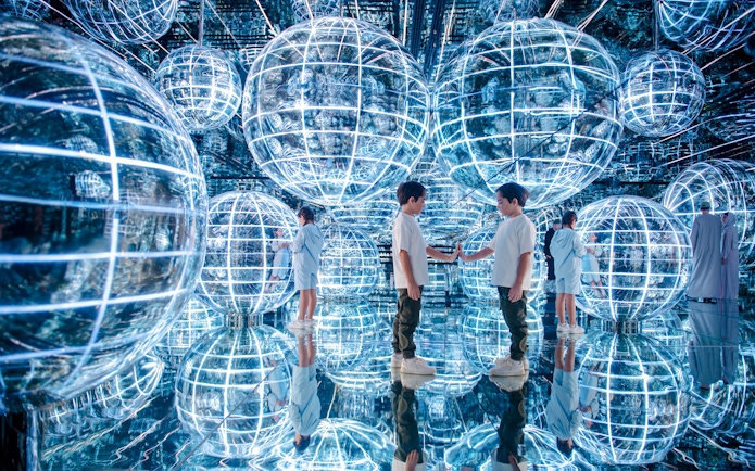 Kids interacting with glowing spheres in Luna zone, AYA universe, Dubai.