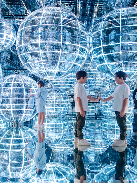 Kids interacting with glowing spheres in Luna zone, AYA universe, Dubai.
