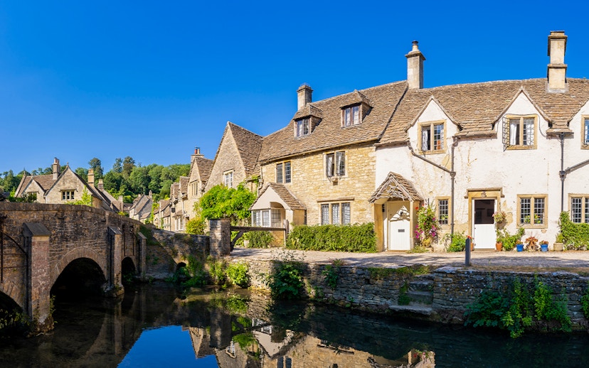 Stone cottages and bridge in a Cotswolds village, England, UK.