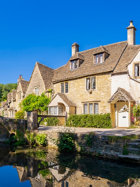Stone cottages and bridge in a Cotswolds village, England, UK.
