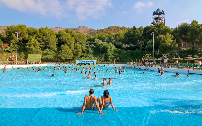 Family enjoying wave pool at Aqualand Costa Adeje, Tenerife.