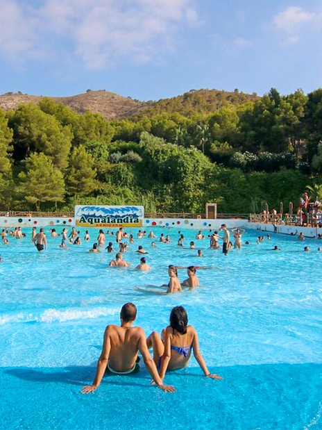 Family enjoying wave pool at Aqualand Costa Adeje, Tenerife.