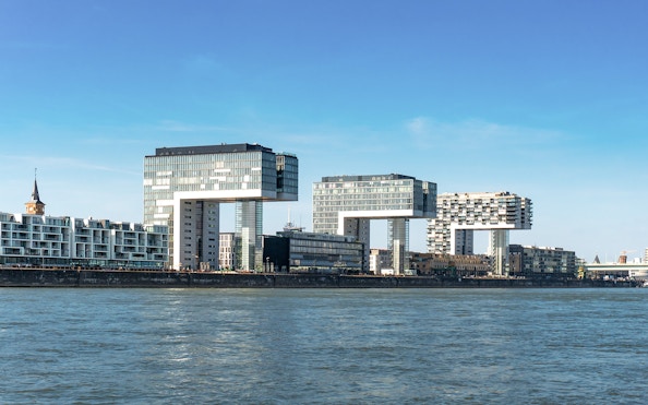 Kranhäuser buildings along the Rhine River in Cologne Harbour during the day.