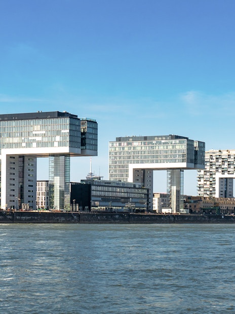 Kranhäuser buildings along the Rhine River in Cologne Harbour during the day.