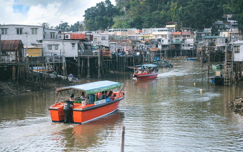 Boats navigating the stilt houses of Tai O fishing village, Hong Kong.