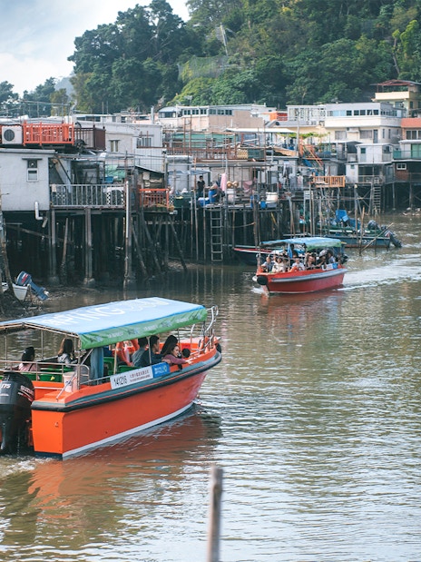 Boats navigating the stilt houses of Tai O fishing village, Hong Kong.