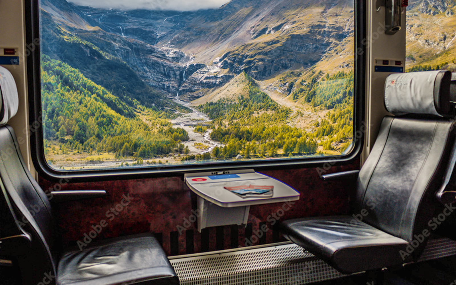 A woman at a counter, purchasing her tickets via phone