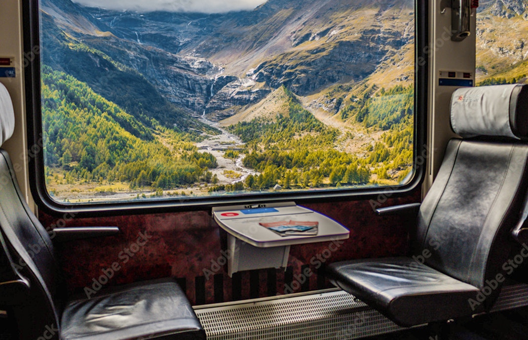 A woman at a counter, purchasing her tickets via phone