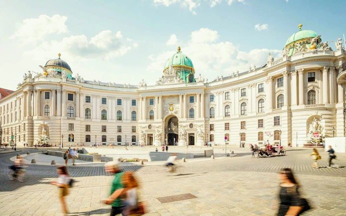 Hofburg Palace exterior with tourists, Vienna, featuring Sisi Museum and Imperial Apartment.