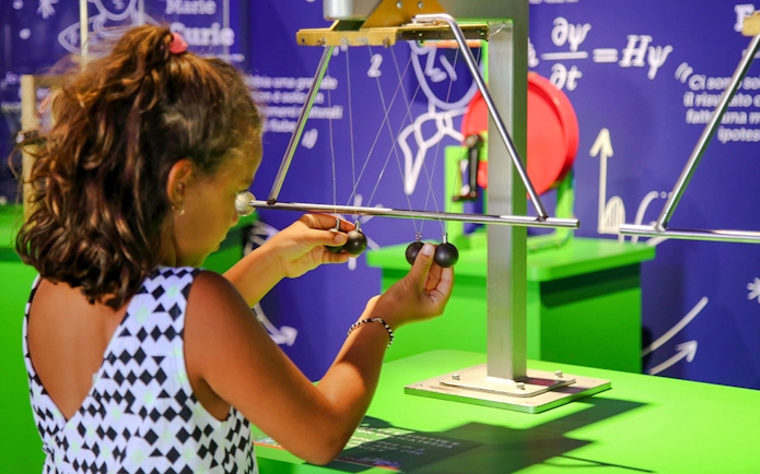 Child interacting with a physics exhibit at Italia in Miniatura, Italy.