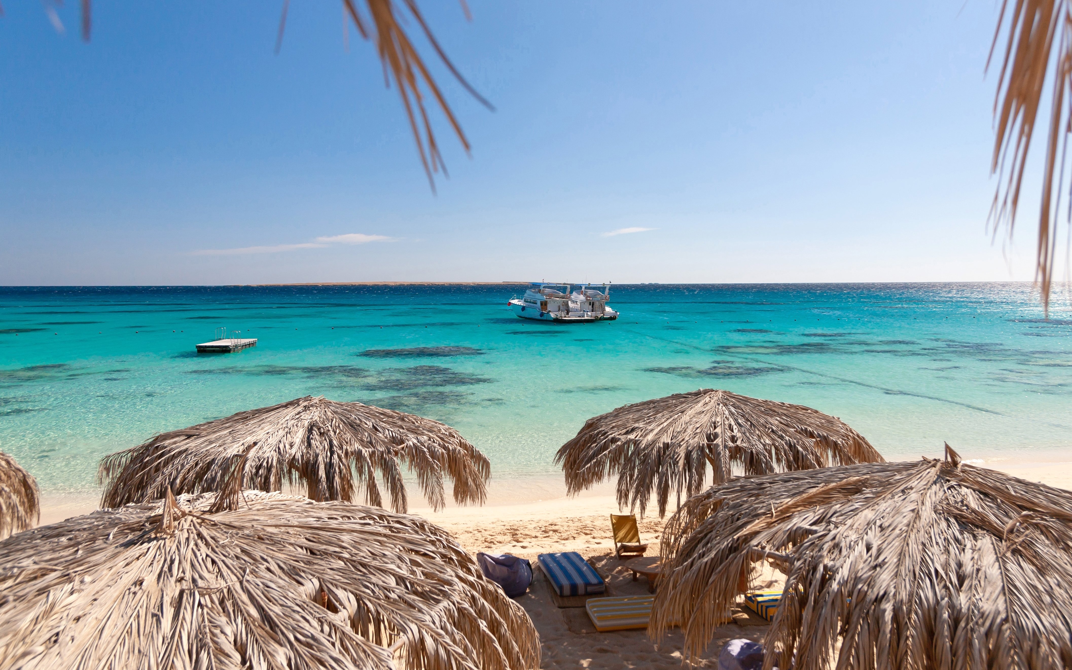 Panoramic view of sea and cruise from Giftun Island, Hurghada with beach umbrellas.