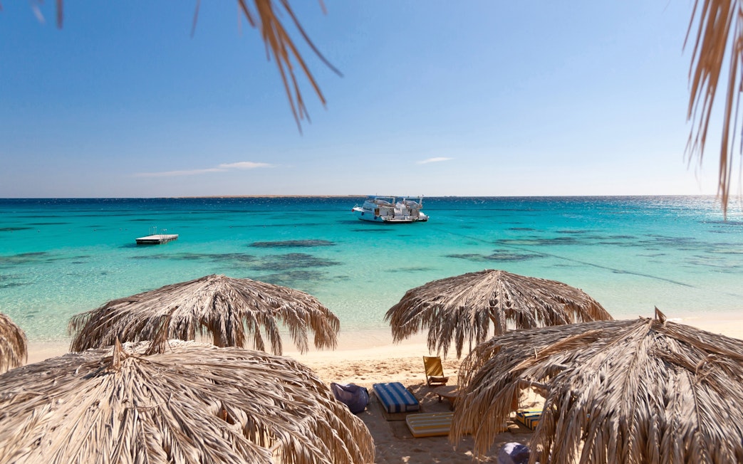 Panoramic view of sea and cruise from Giftun Island, Hurghada with beach umbrellas.